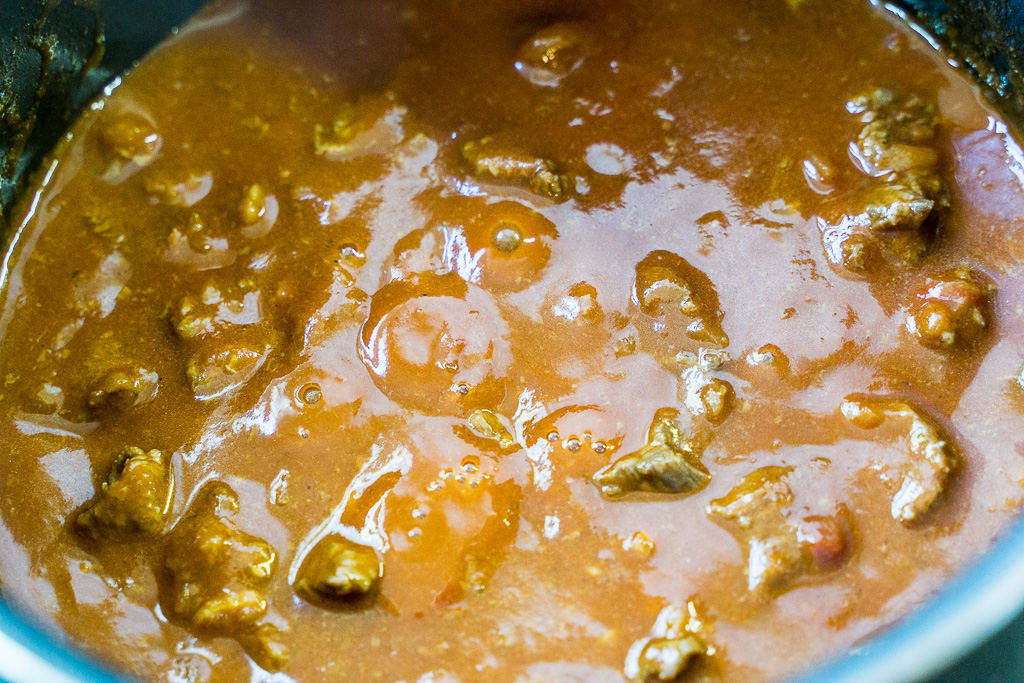 From now, boil it while you add water/broth/beer. Do not let the gravy drop below this level. This is the right time to add the tomato puree (right).